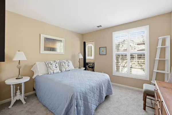 a spacious bedroom with a bed and a window