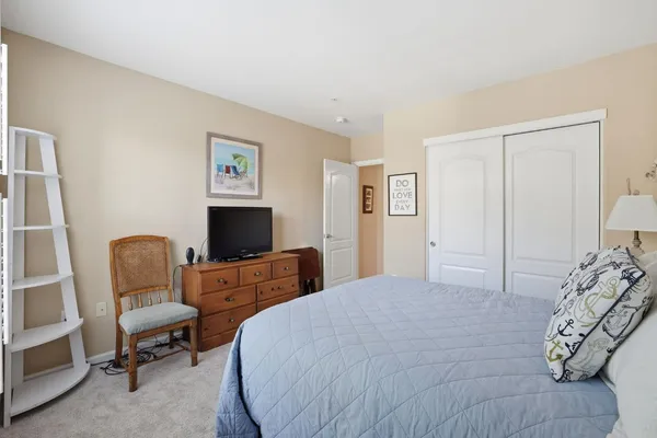 a bedroom with a bed and a couch