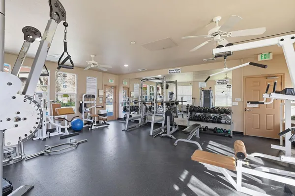 a gym room with lots of gym equipment