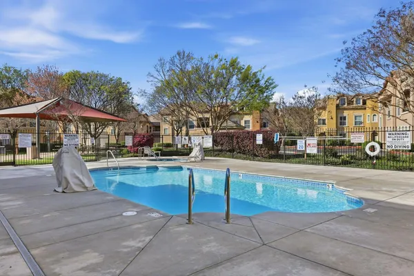 a view of a swimming pool with a patio