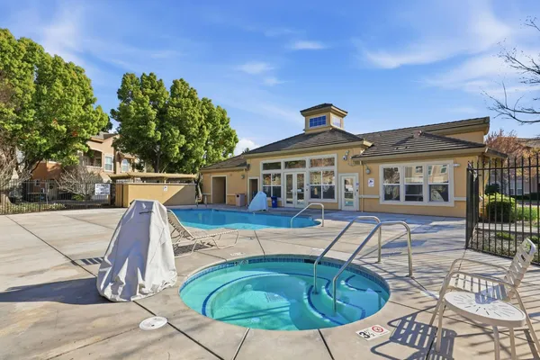 a view of a house with swimming pool and sitting area