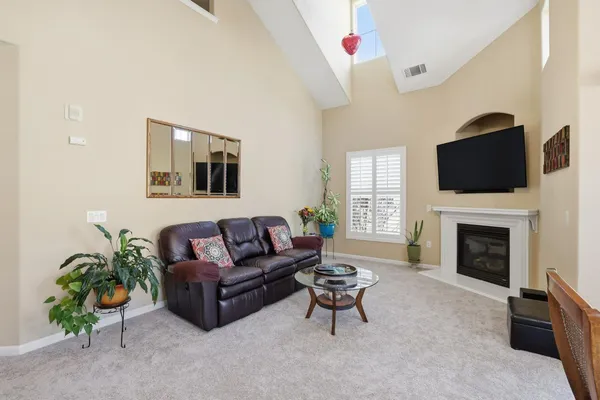 a living room with furniture a fireplace and a flat screen tv
