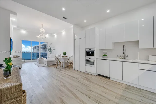 a kitchen with white cabinets and counter space