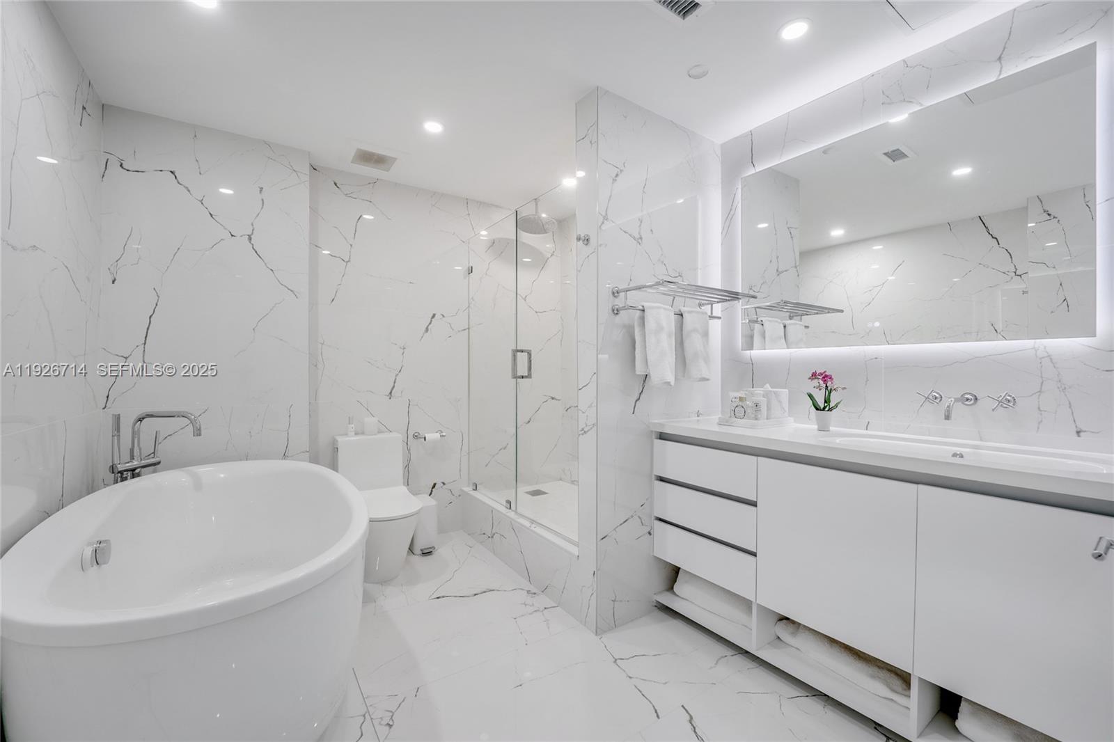 2301 Collins Avenue, Unit 1625 Miami Beach, FL 33139 - Photo 7 of 19 a bathroom with a bathtub a sink a toilet and a shower