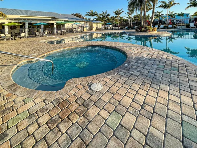 a view of a swimming pool with outdoor seating