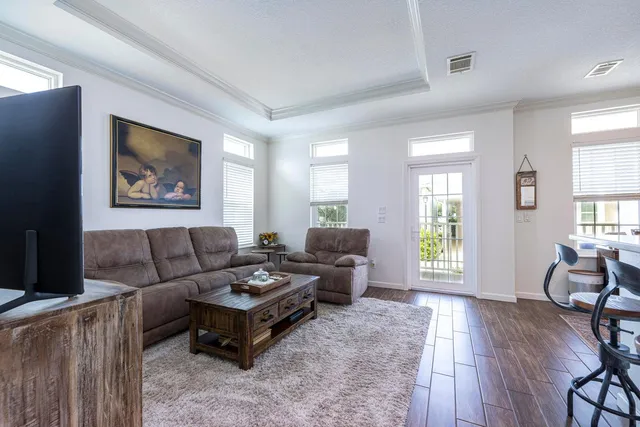 a living room with furniture and wooden floor