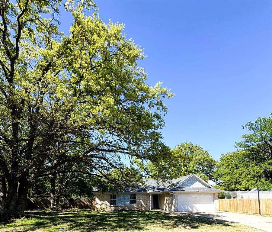 7060 Jay Lane Azle, TX 76020 - Photo 2 of 36 Look at these gorgeous, tall, shade trees! The bluebonnet flowers are in bloom here too!