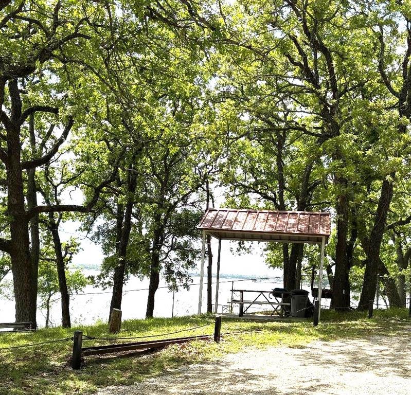 7060 Jay Lane Azle, TX 76020 - Photo 23 of 36 a view of a swimming pool and trees in the background