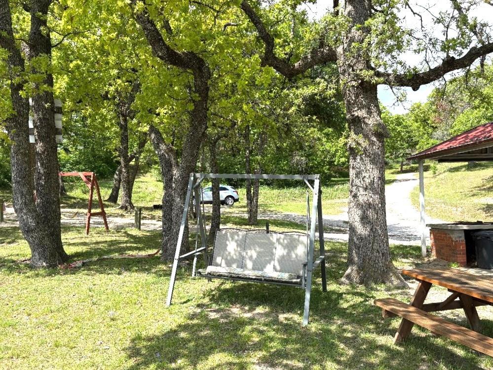 7060 Jay Lane Azle, TX 76020 - Photo 24 of 36 a backyard of a house with yard and outdoor seating