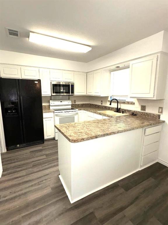 7060 Jay Lane Azle, TX 76020 - Photo 5 of 36 a kitchen with granite countertop a refrigerator and a stove top oven