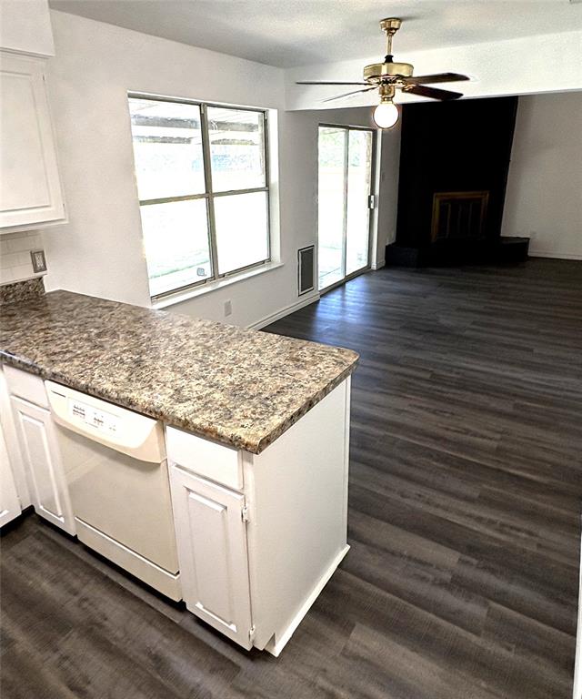 7060 Jay Lane Azle, TX 76020 - Photo 6 of 36 a kitchen with kitchen island granite countertop wooden cabinets a sink and a stove