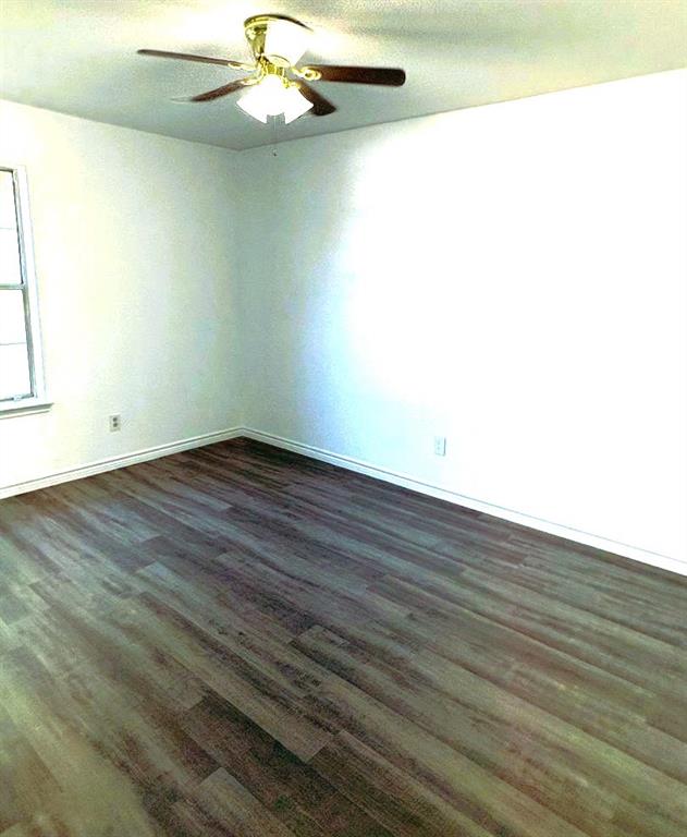 7060 Jay Lane Azle, TX 76020 - Photo 10 of 36 an empty room with wooden floor and windows