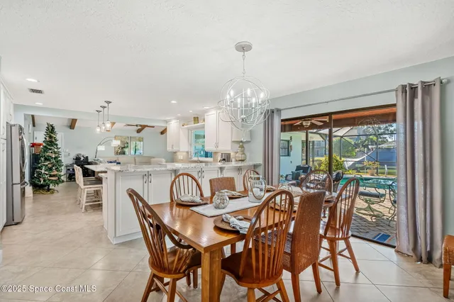 a dining room with furniture a chandelier and a rug