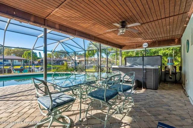a view of a patio with a table chairs and a backyard