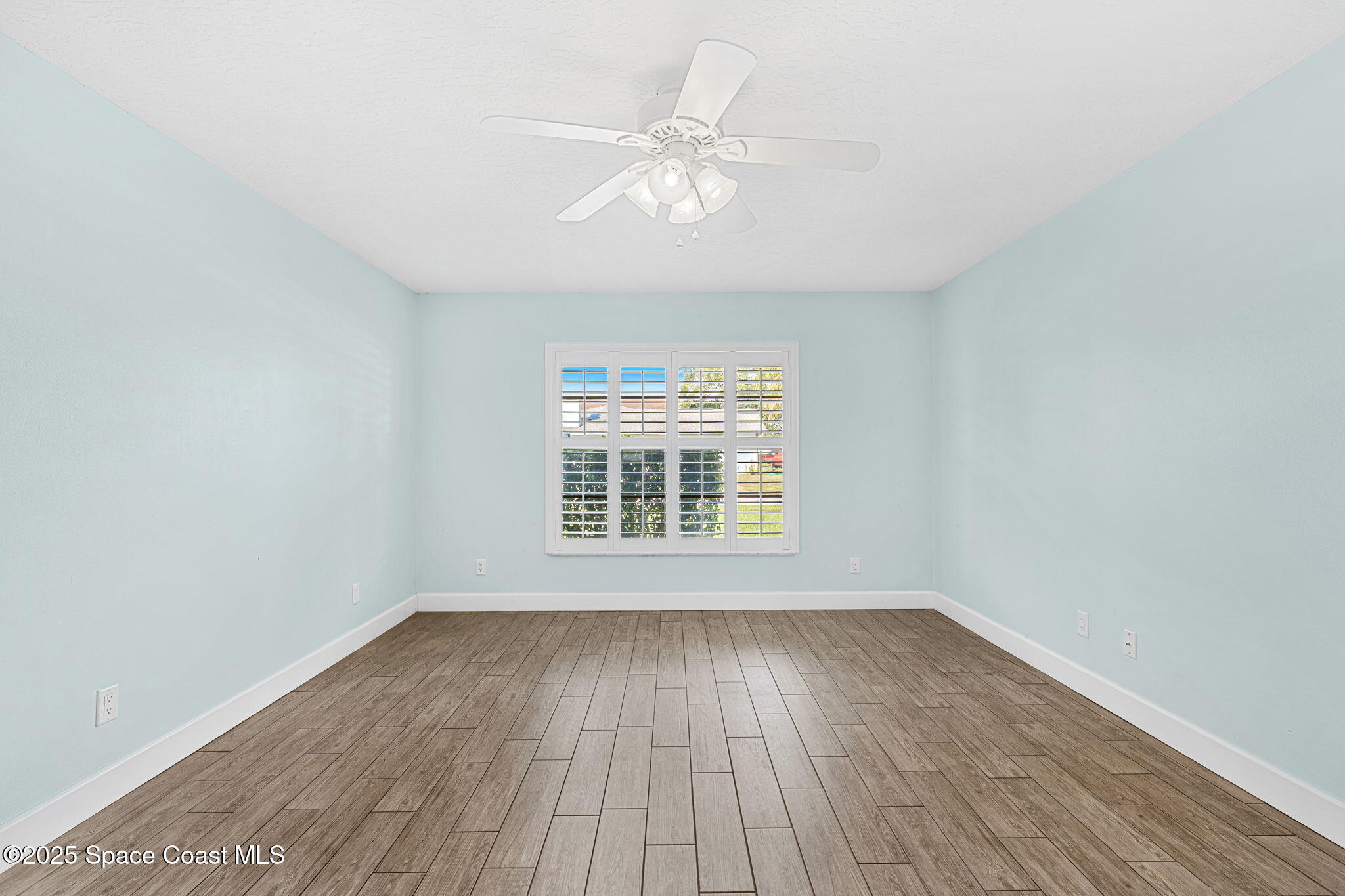 615 Mark And Randy Drive Satellite Beach, FL 32937 - Photo 18 of 40 wooden floor in an empty room with a window