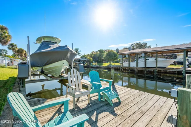 a view of a roof deck with couches chairs and wooden floor