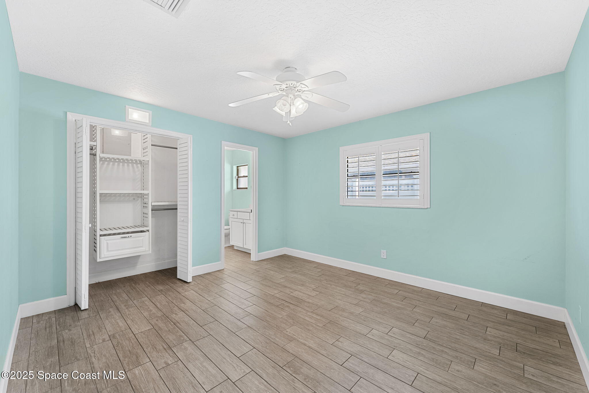 615 Mark And Randy Drive Satellite Beach, FL 32937 - Photo 23 of 40 wooden floor in an empty room with a window