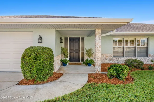 a view of a house with potted plants