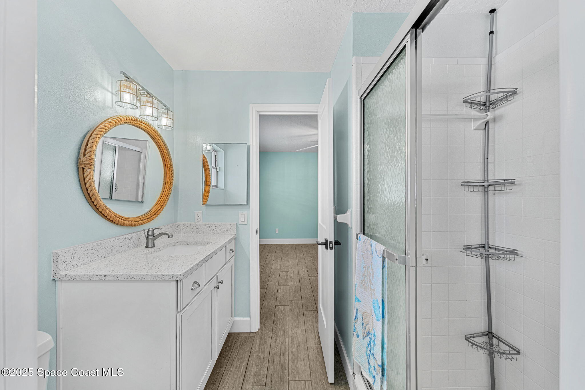 615 Mark And Randy Drive Satellite Beach, FL 32937 - Photo 25 of 40 a bathroom with a double vanity sink a mirror and a shower