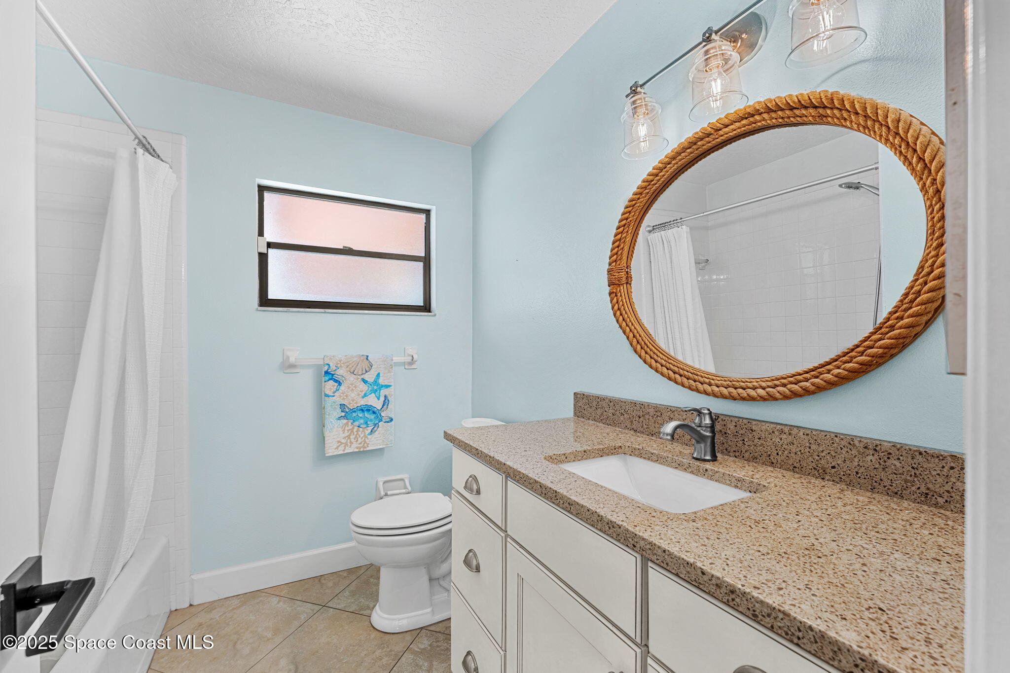 615 Mark And Randy Drive Satellite Beach, FL 32937 - Photo 29 of 40 a bathroom with a granite countertop toilet a sink and a mirror