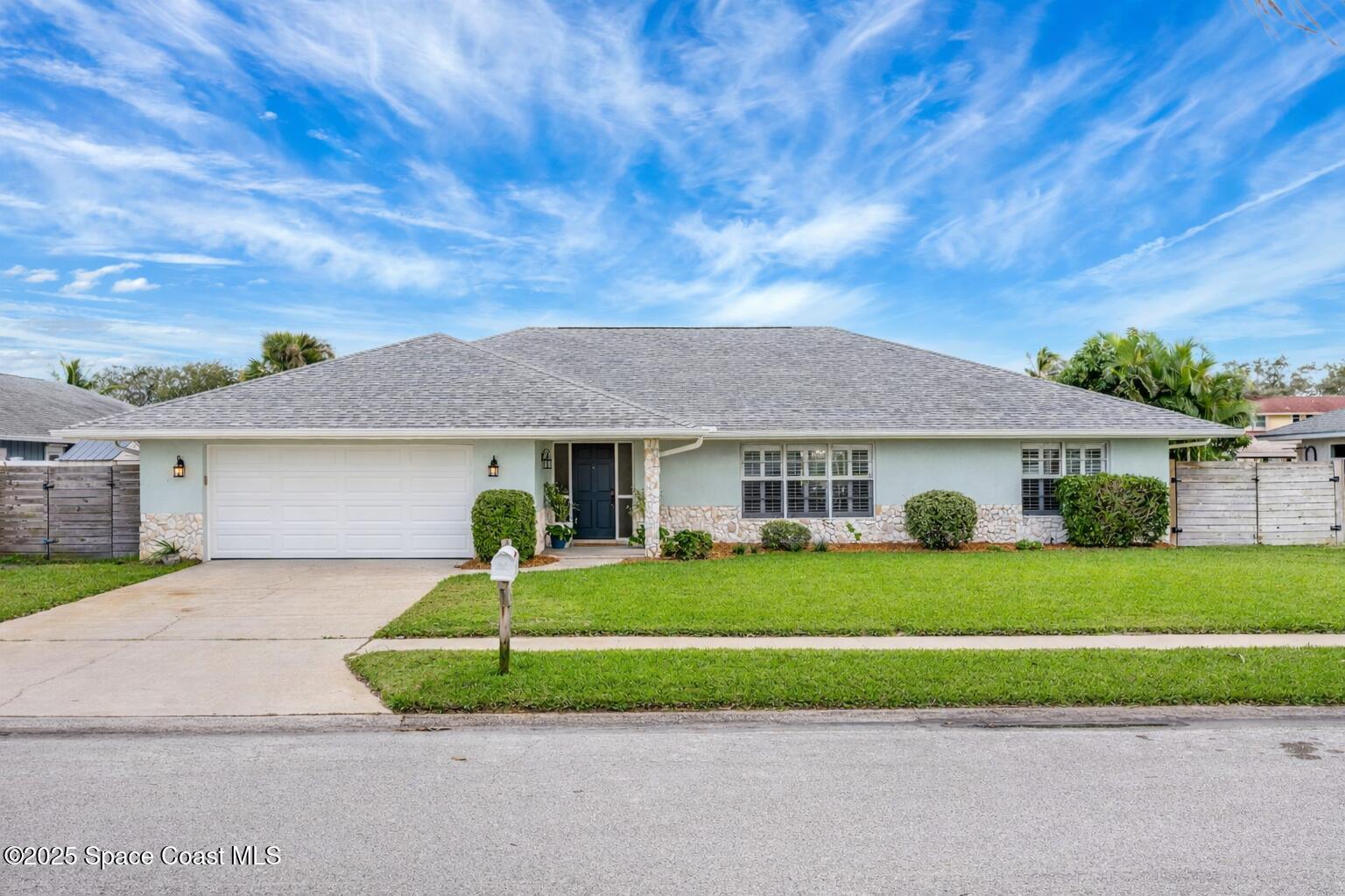 615 Mark And Randy Drive Satellite Beach, FL 32937 - Photo 3 of 40 a front view of a house with a garden