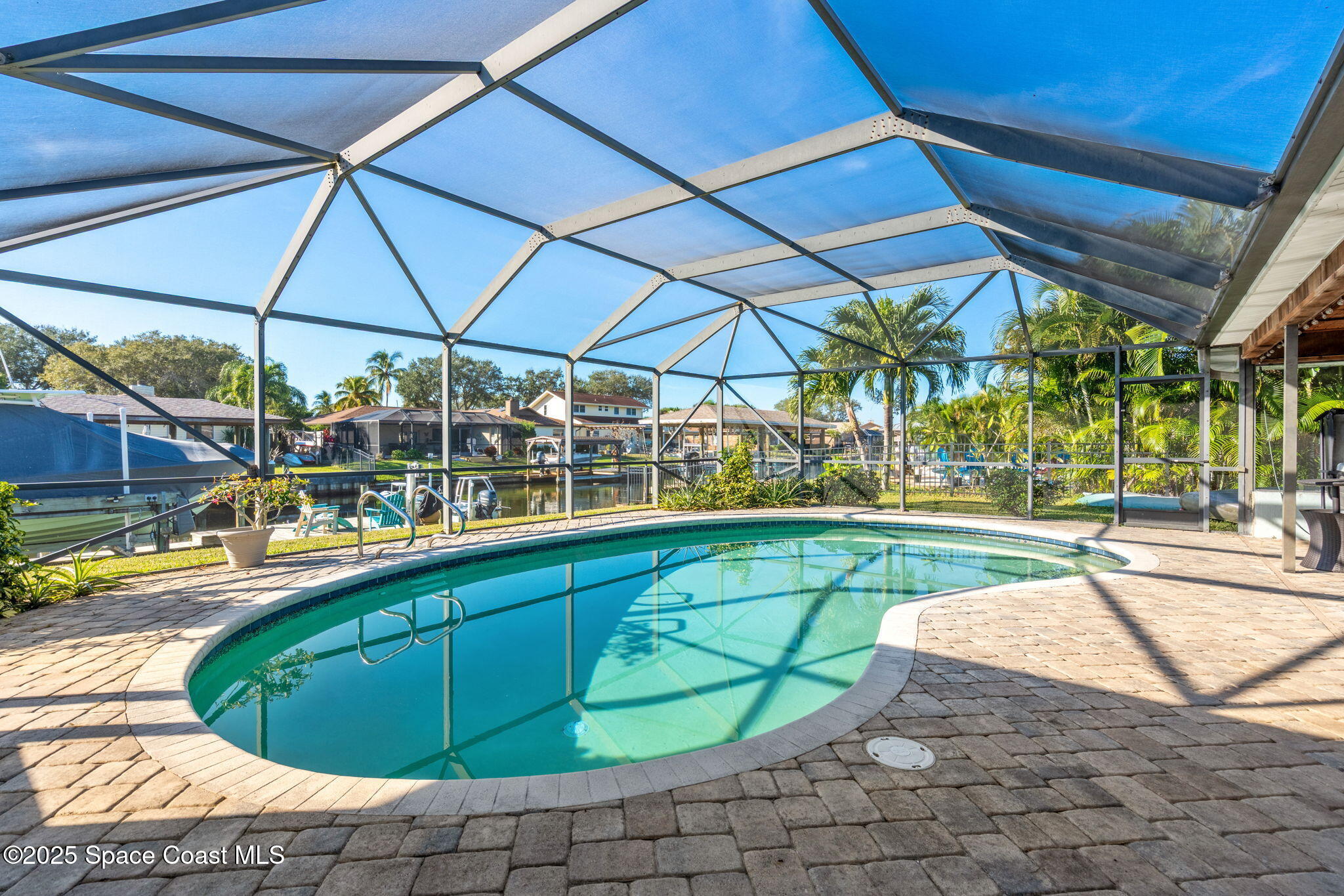 615 Mark And Randy Drive Satellite Beach, FL 32937 - Photo 33 of 40 a view of a swimming pool with a patio