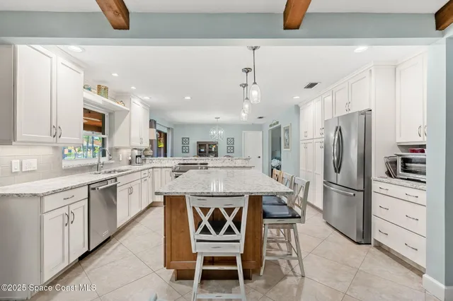a kitchen with a refrigerator a sink and cabinets