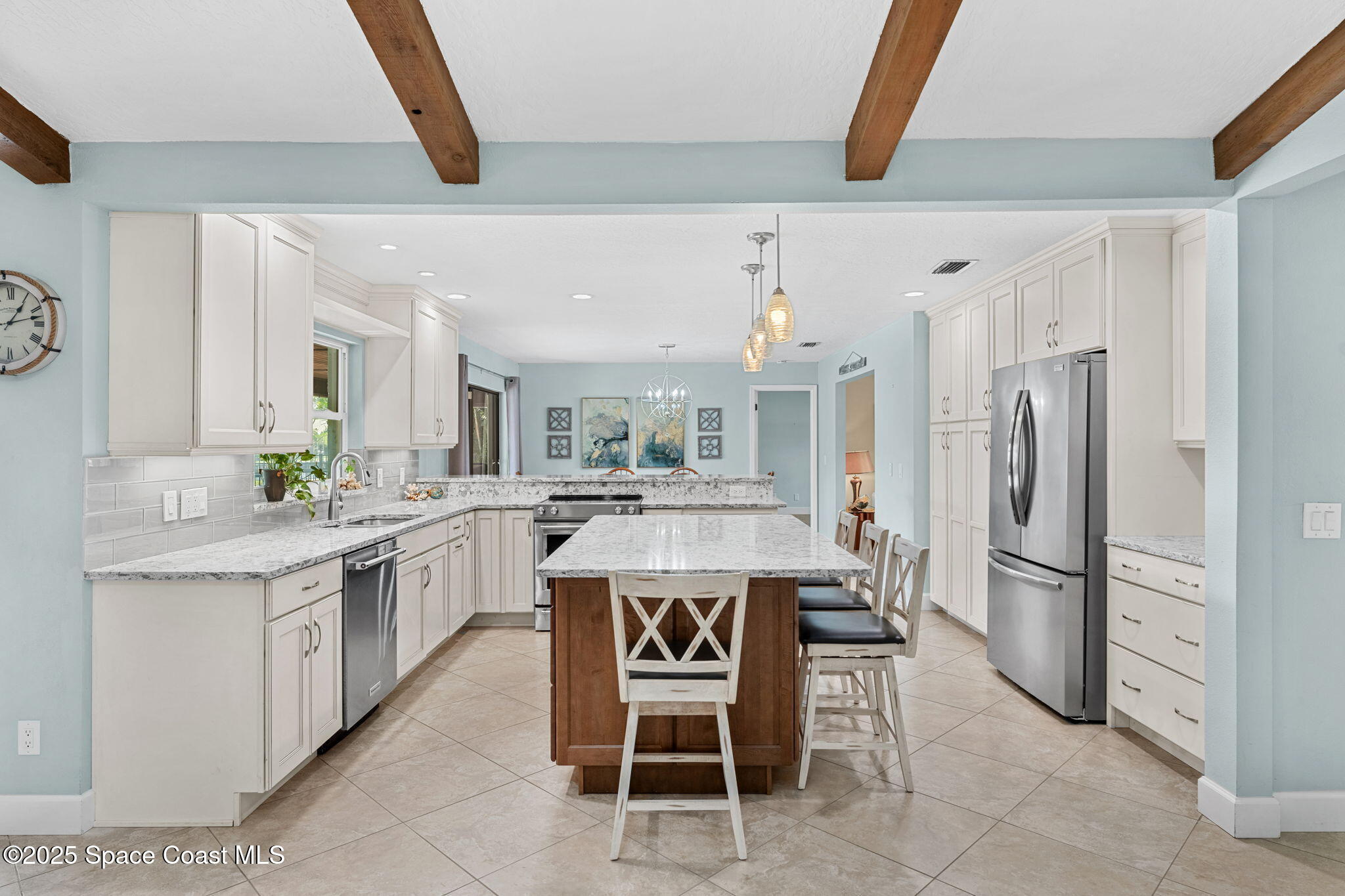 615 Mark And Randy Drive Satellite Beach, FL 32937 - Photo 10 of 40 a kitchen with a refrigerator a sink and a stove