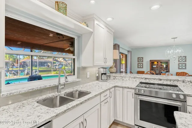 a kitchen with a sink stove and cabinets