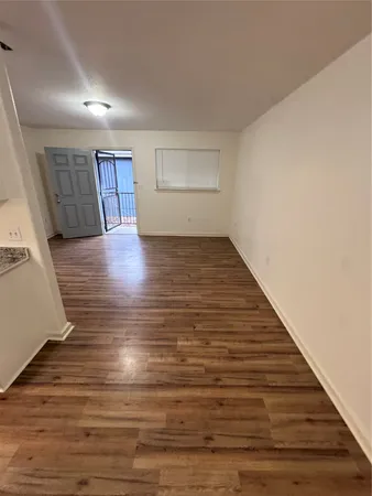 wooden floor in a room next to a window