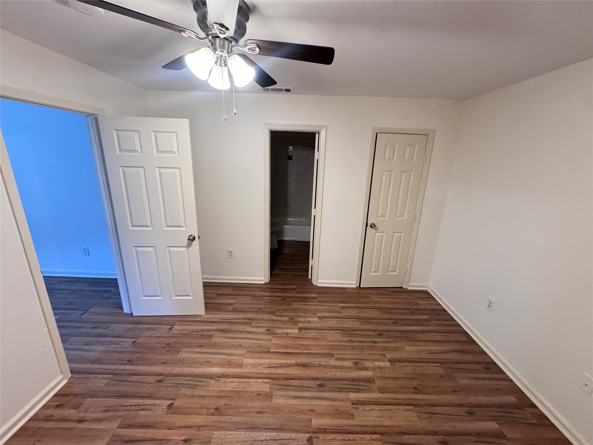 8207 Sam Rayburn Drive, Unit 204 Austin, TX 78753 - Photo 18 of 27 a view of an empty room with wooden floor and a ceiling fan