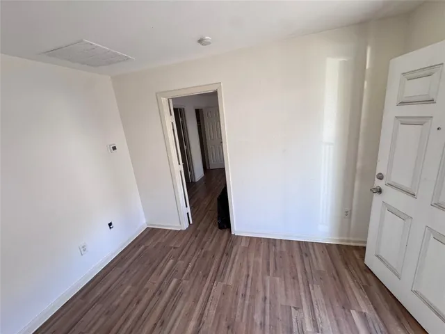 a view of a room with wooden floor and white doors
