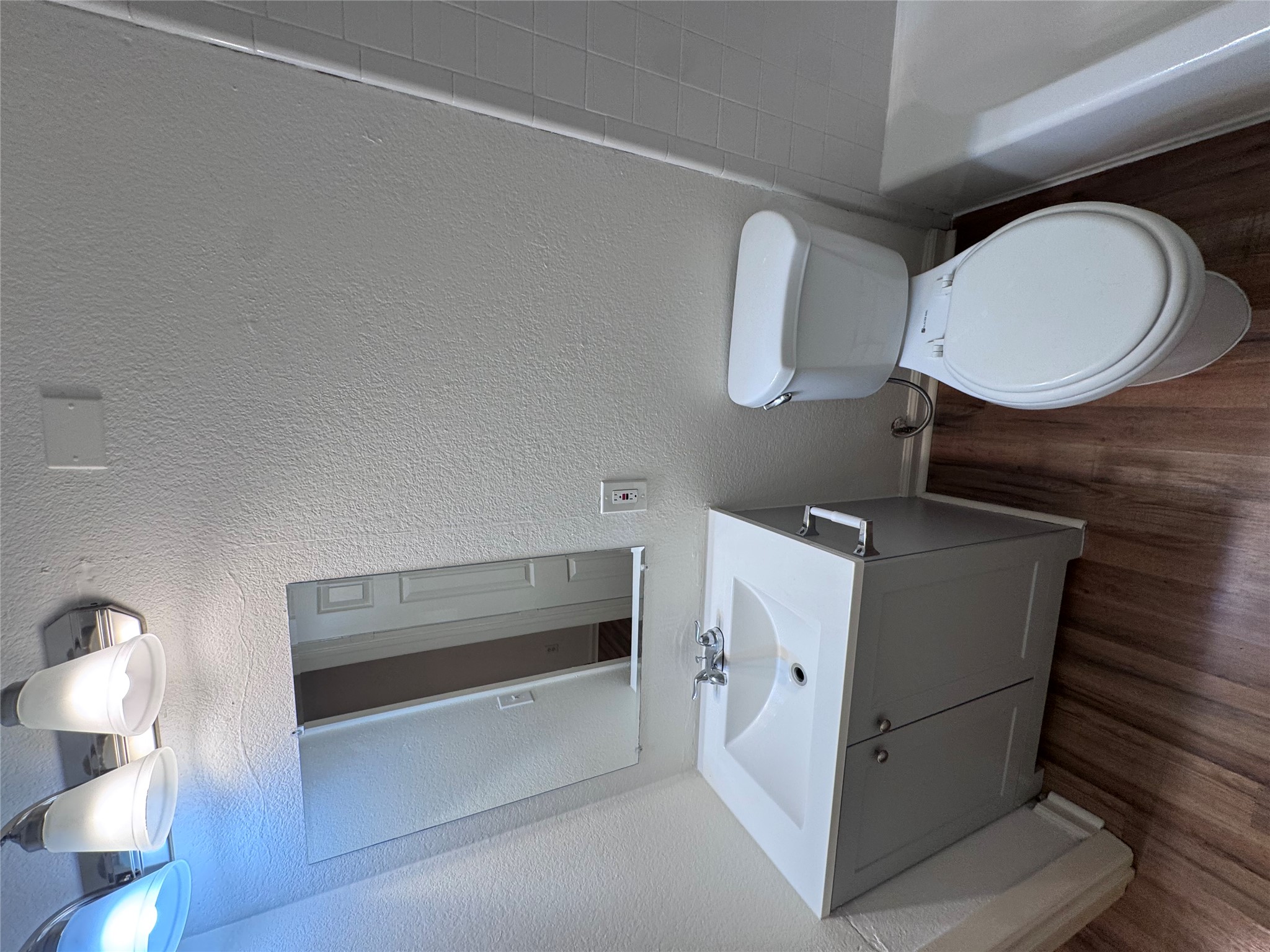 8207 Sam Rayburn Drive, Unit 204 Austin, TX 78753 - Photo 25 of 27 a bathroom with a toilet sink and mirror