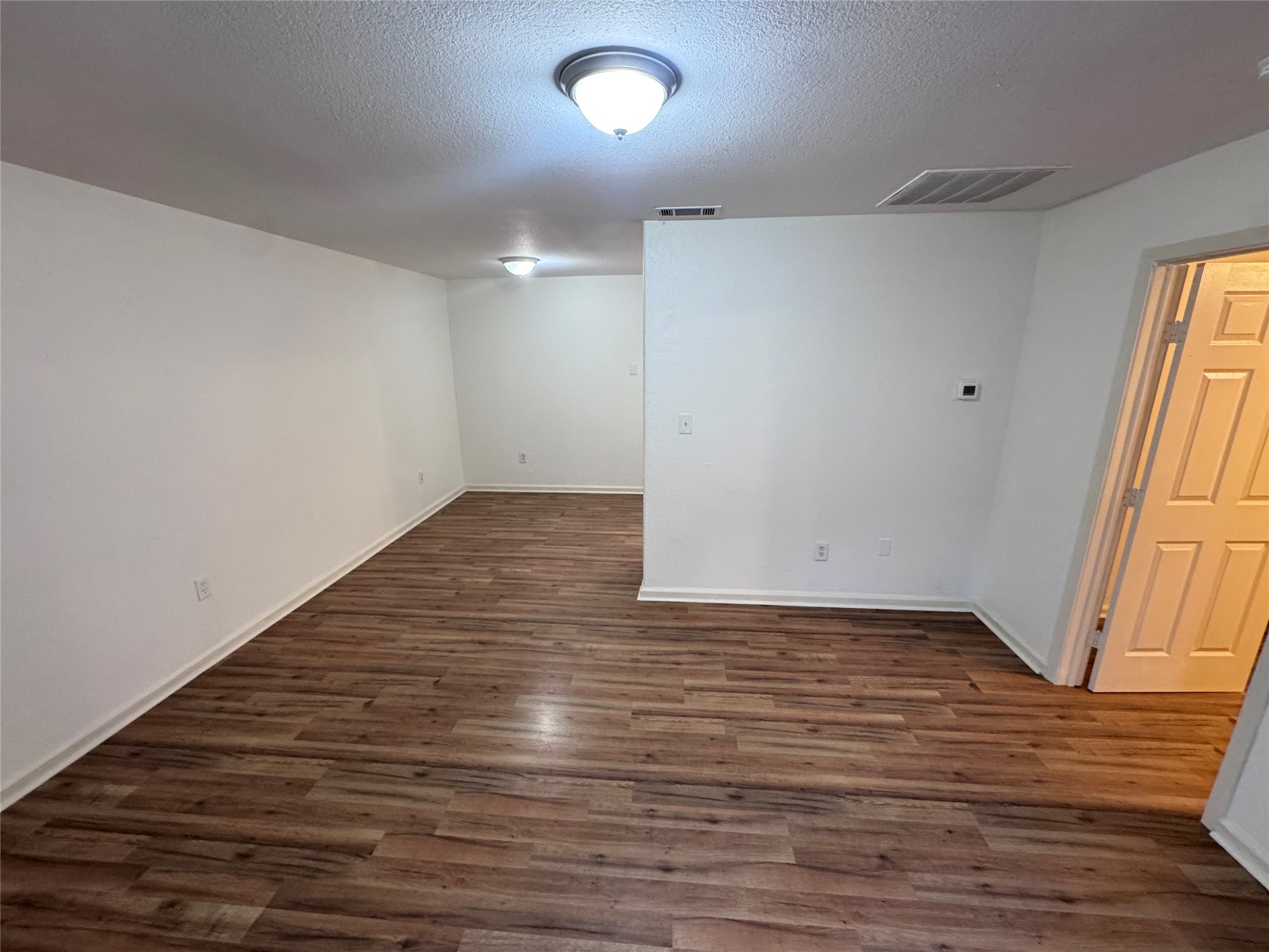 8207 Sam Rayburn Drive, Unit 204 Austin, TX 78753 - Photo 5 of 27 wooden floor in an empty room with a window