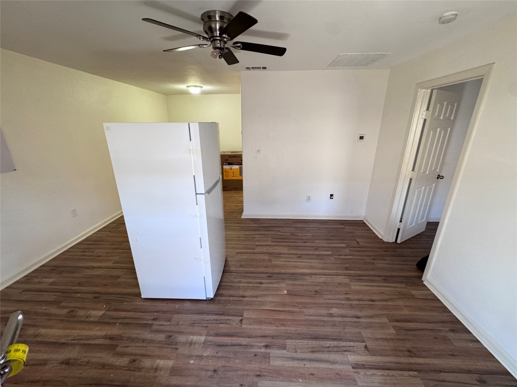 8207 Sam Rayburn Drive, Unit 204 Austin, TX 78753 - Photo 6 of 8 a view of an empty room with wooden floor and ceiling fan