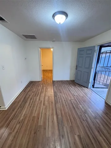 a kitchen with wooden floors and a stove