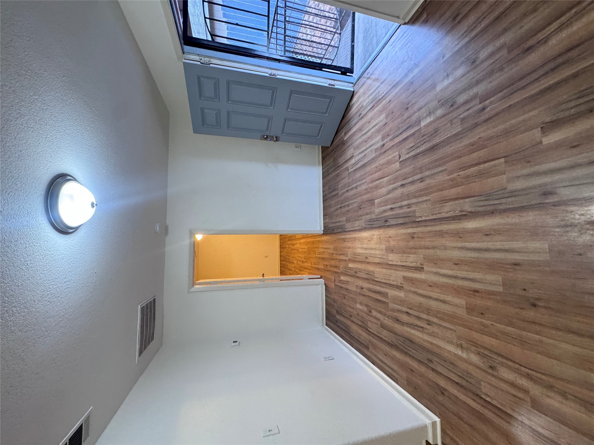 8207 Sam Rayburn Drive, Unit 204 Austin, TX 78753 - Photo 7 of 27 wooden floor in an empty room with a window