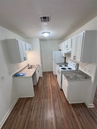 a kitchen with white cabinets and white appliances
