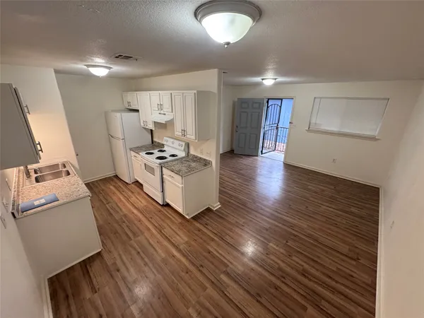 a kitchen with wooden cabinets and a sink