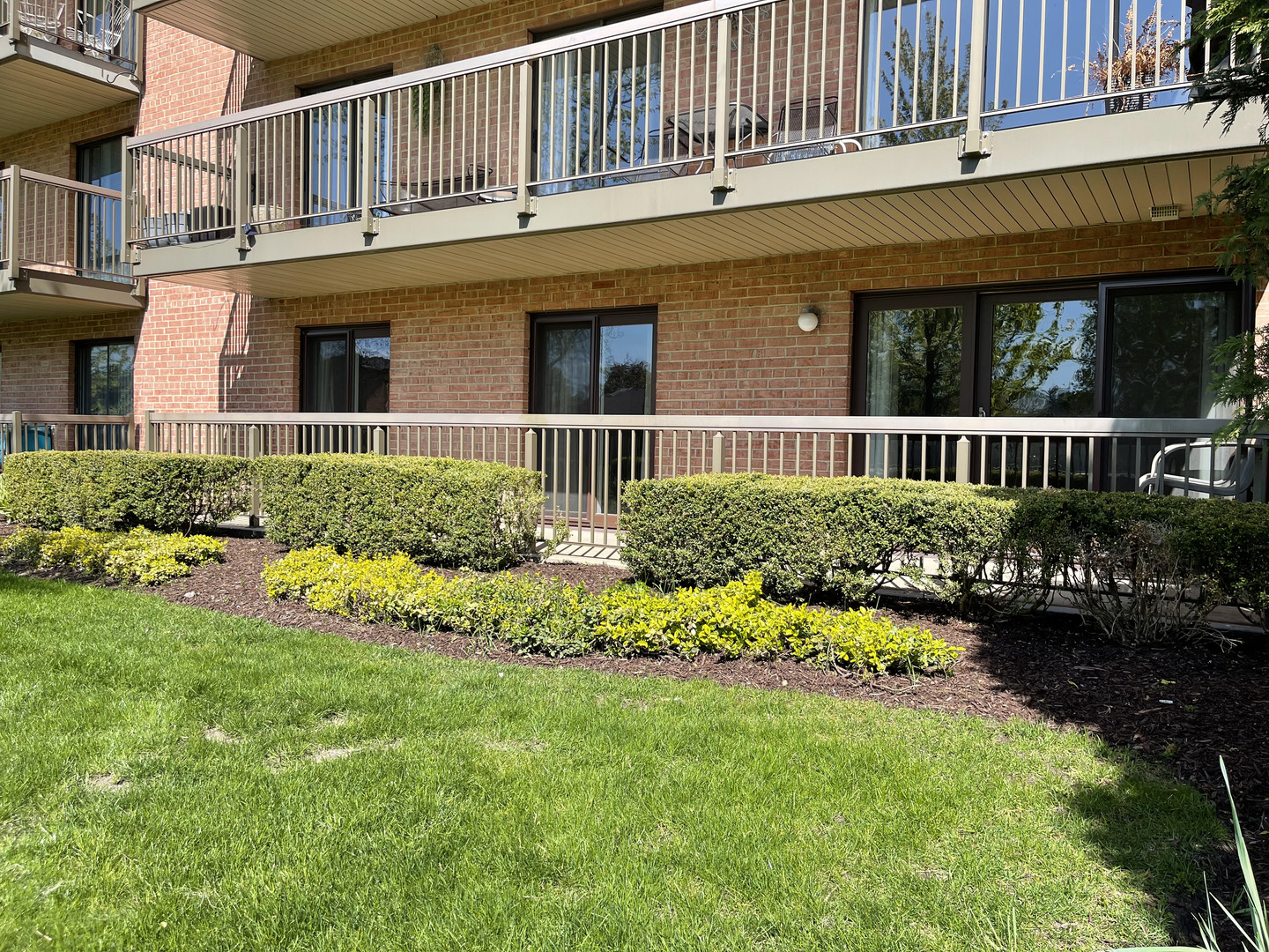 6443 Clarendon Hills Road, Unit 107 Willowbrook, IL 60527 - Photo 13 of 19 front view of a house with a yard