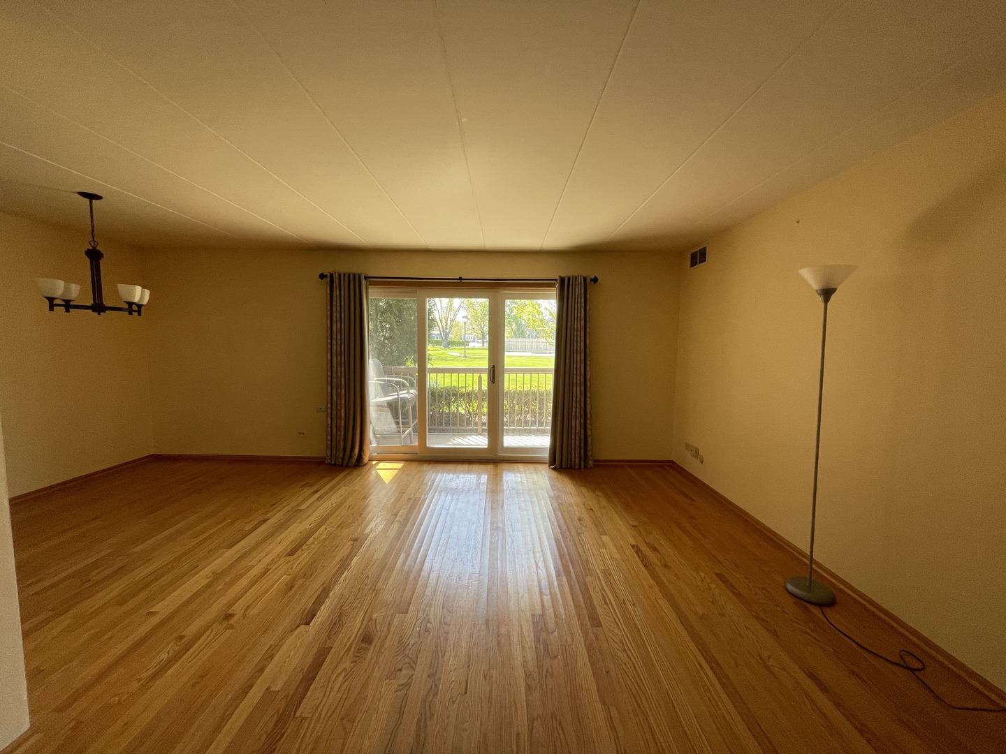 6443 Clarendon Hills Road, Unit 107 Willowbrook, IL 60527 - Photo 4 of 19 an empty room with wooden floor and windows
