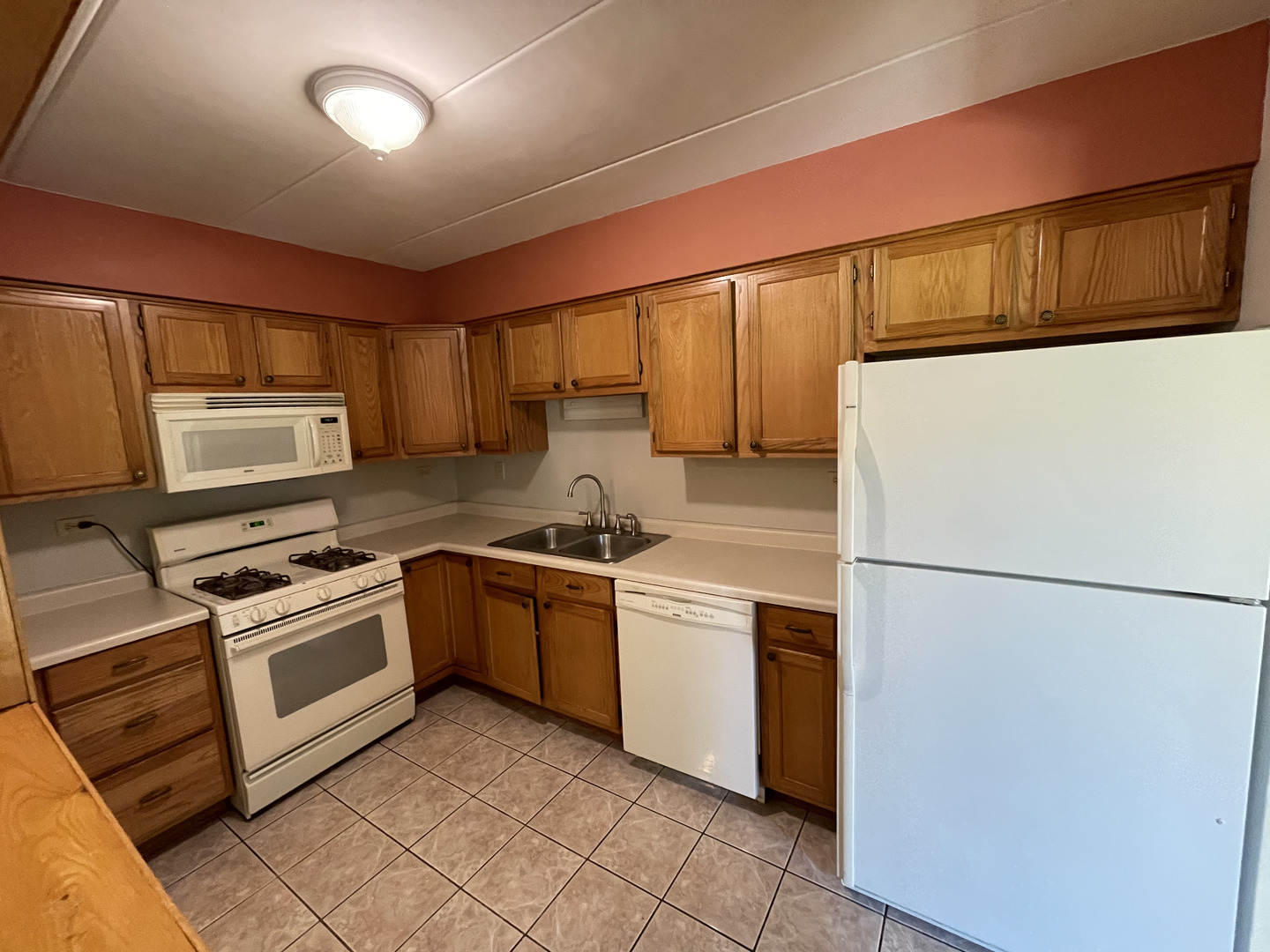 6443 Clarendon Hills Road, Unit 107 Willowbrook, IL 60527 - Photo 6 of 19 a kitchen with stainless steel appliances granite countertop a refrigerator sink stove and microwave