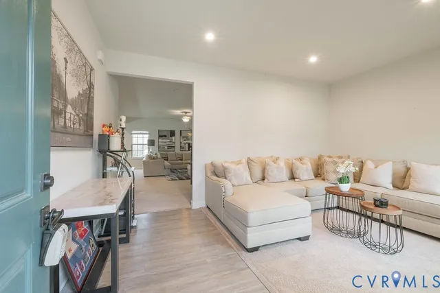 a living room with furniture and a wooden floor