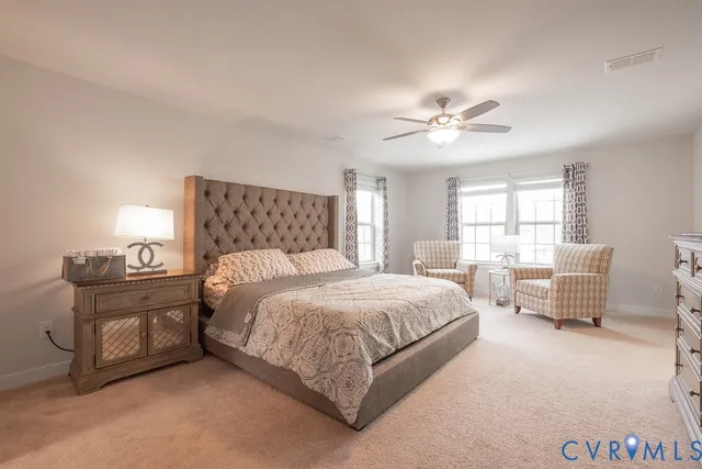 a spacious bedroom with a bed and a couch