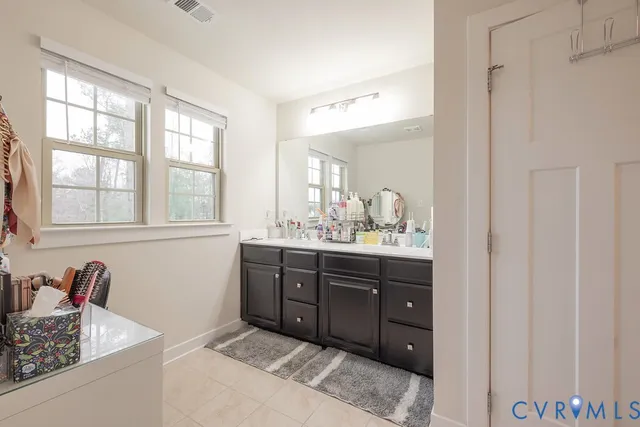 a spacious bathroom with a sink double vanity and a mirror