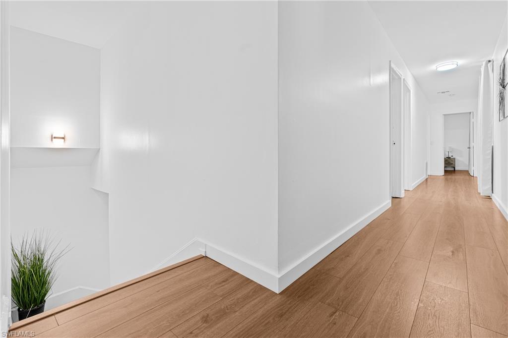 3303 6th Street Southwest Lehigh Acres, FL 33976 - Photo 13 of 23 a view of a hallway with wooden floor