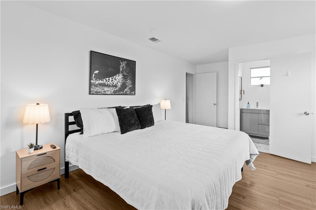 3303 6th Street Southwest Lehigh Acres, FL 33976 - Photo 14 of 23 a bedroom with bed and wooden floor