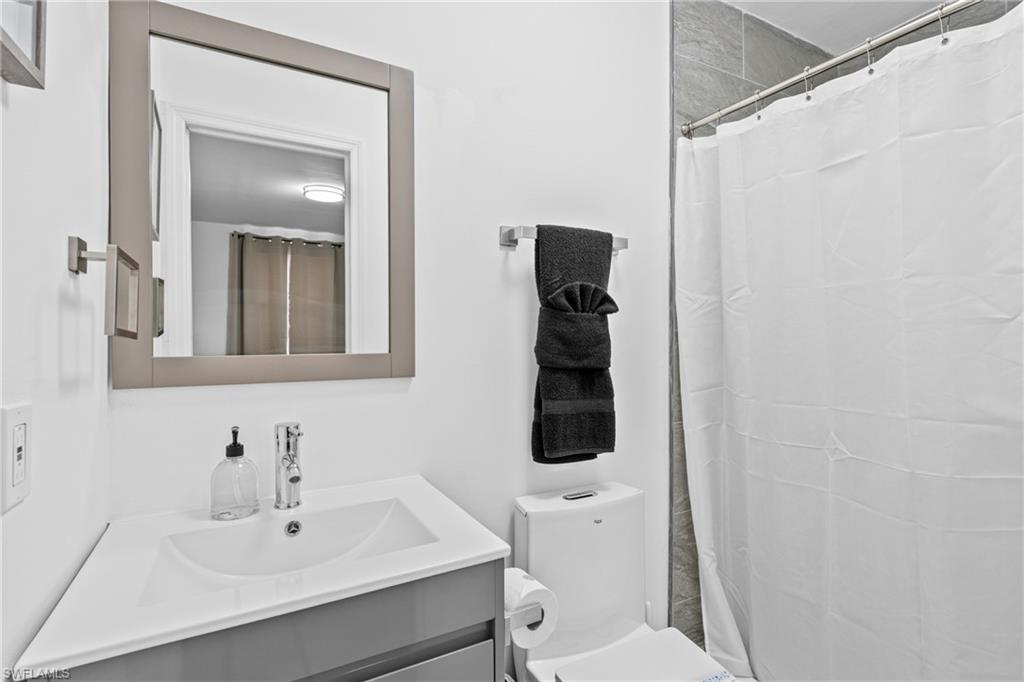 3303 6th Street Southwest Lehigh Acres, FL 33976 - Photo 18 of 23 a bathroom with a sink a toilet and shower