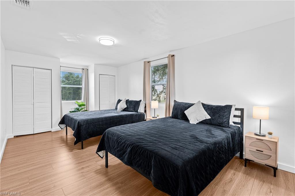 3303 6th Street Southwest Lehigh Acres, FL 33976 - Photo 20 of 23 a bedroom with two beds and a window