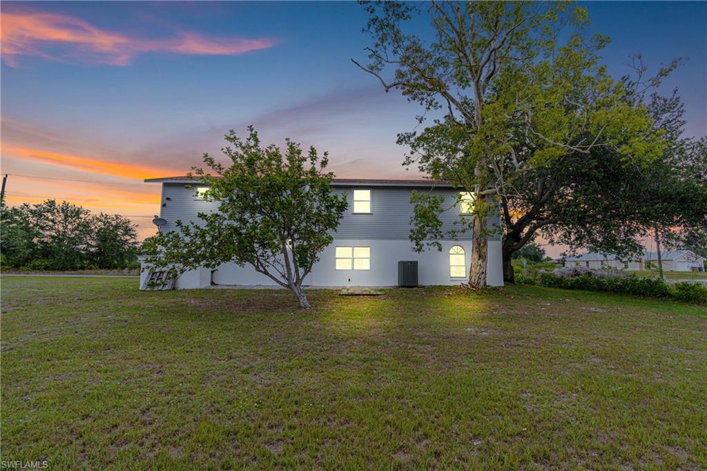 3303 6th Street Southwest Lehigh Acres, FL 33976 - Photo 21 of 23 a front view of a house with a yard